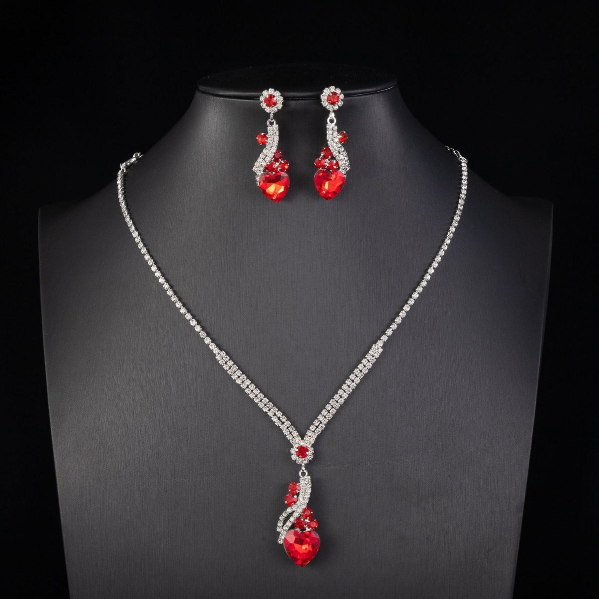 Red-detail necklace and earrings on a black display