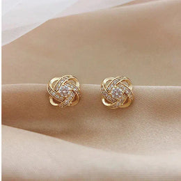 Closer view of gold-tone floral-knot stud earrings