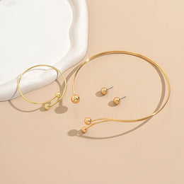 Alternate flat lay of the gold-tone open-collar set