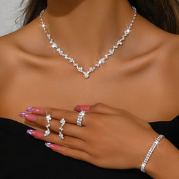 Model wearing the silver-tone necklace, bracelet, earrings and ring set