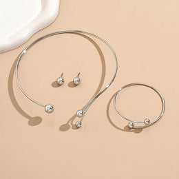 Silver-tone open-collar jewellery set laid flat