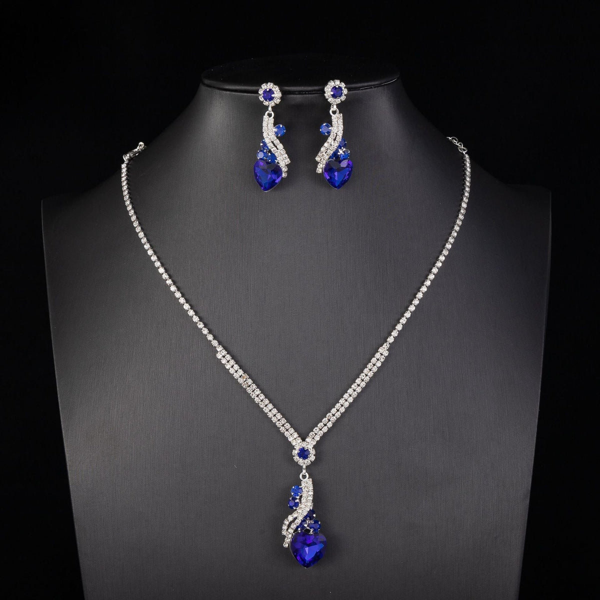 Blue-detail necklace and earrings on a black bust