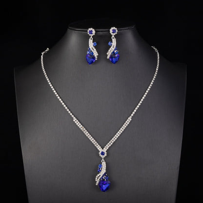 Blue-detail necklace and earrings on a black bust