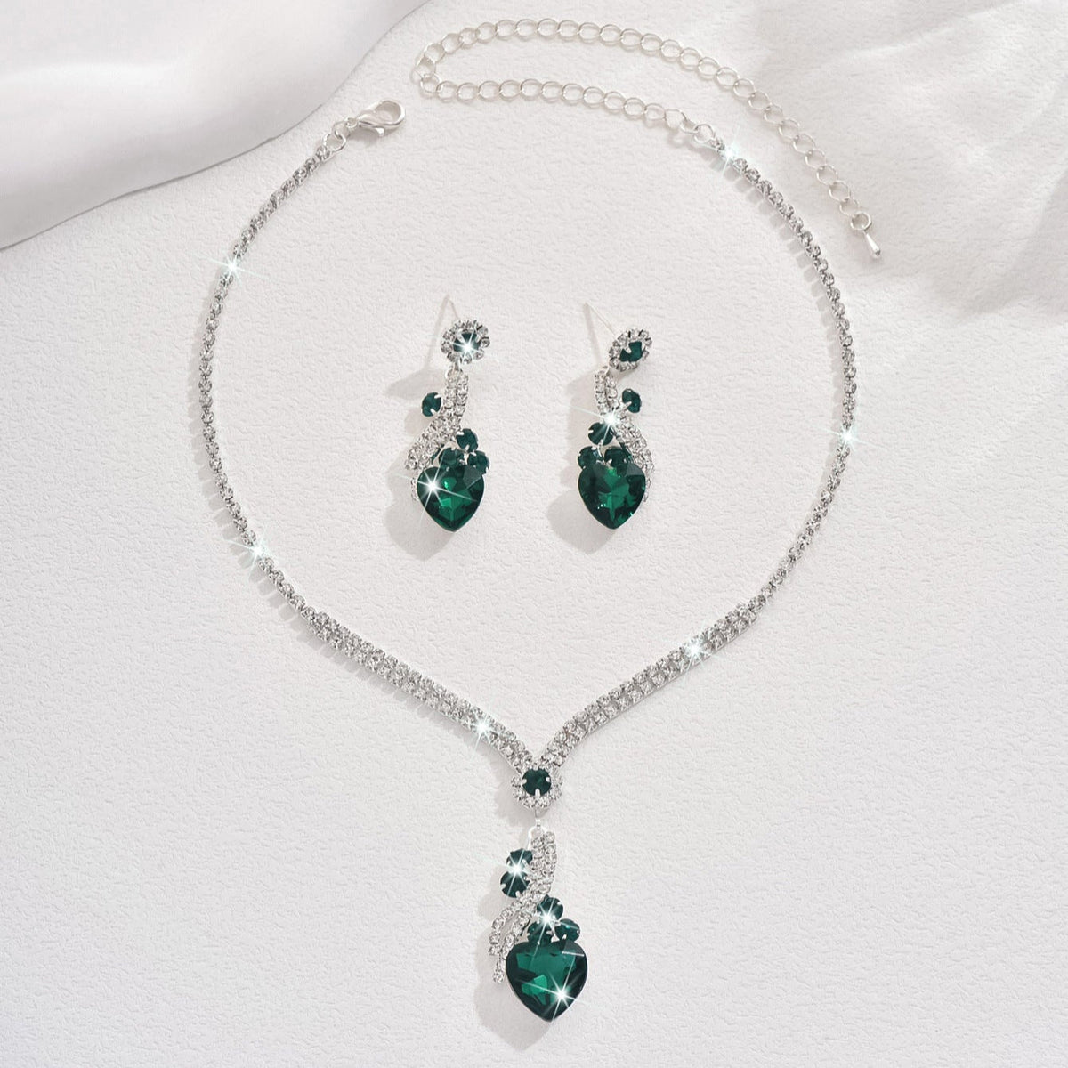 Green-detail necklace and earrings on a white background