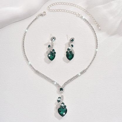 Green-detail necklace and earrings on a white background