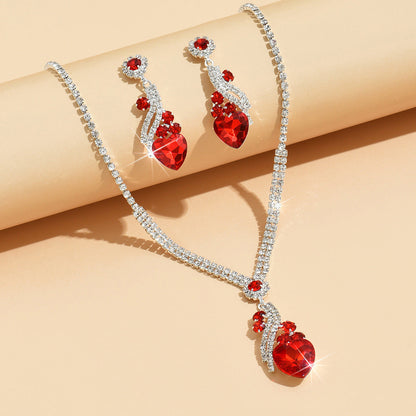 Red-detail necklace and earrings on a light background