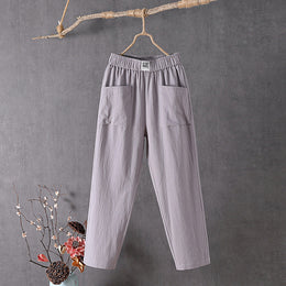 Grey Teresa straight-leg trousers with elastic waist and patch pockets, front view