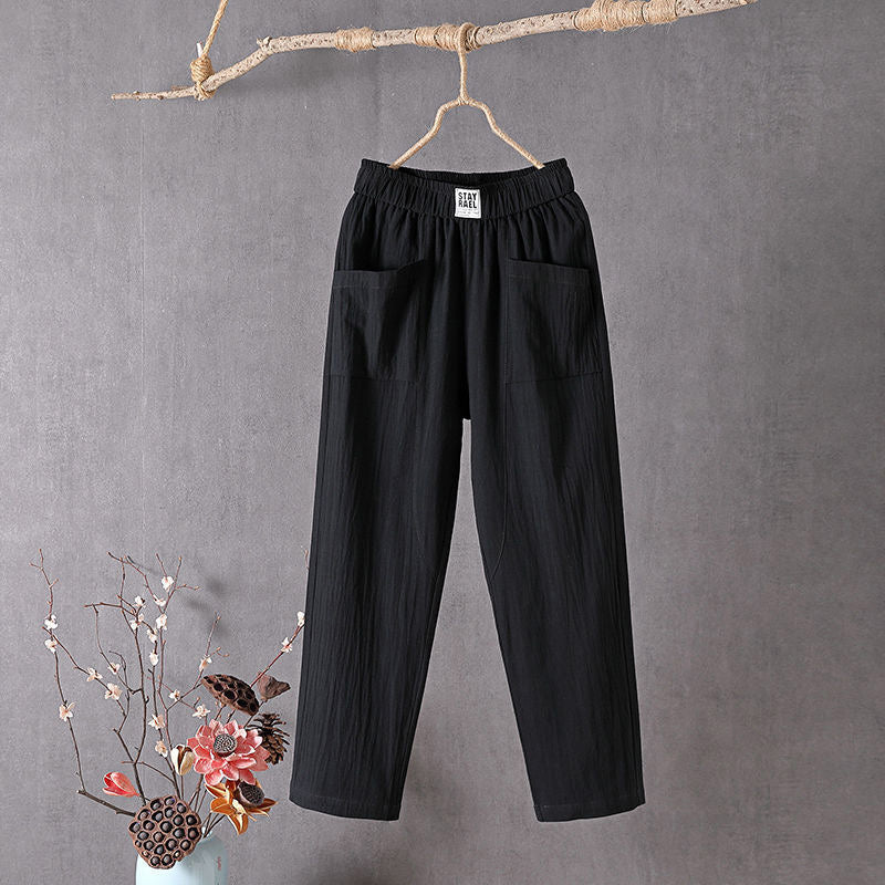 Black Teresa straight-leg trousers with elastic waist and patch pockets, front view