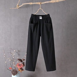 Black Teresa straight-leg trousers with elastic waist and patch pockets, front view